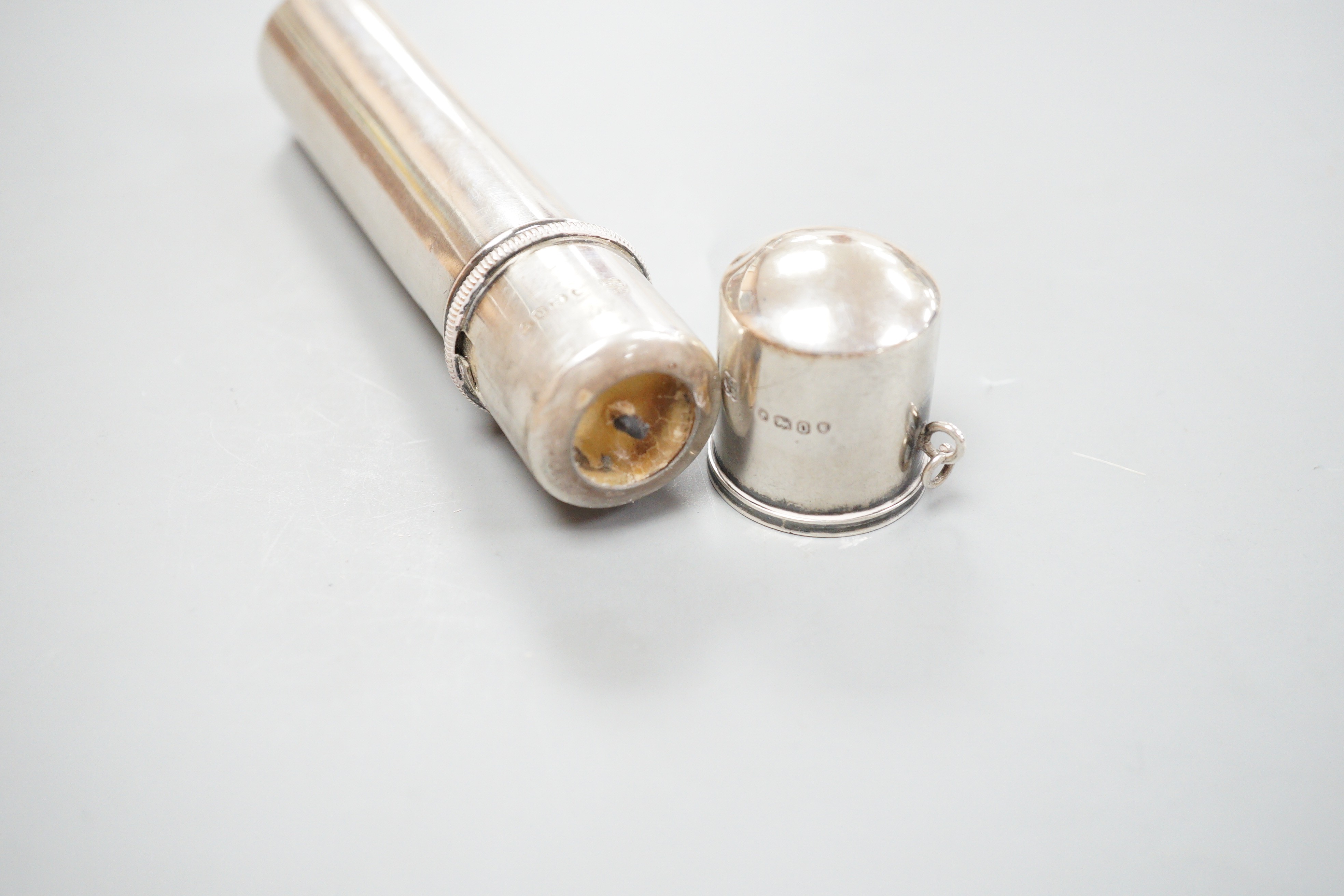A Victorian silver cylindrical cased portable travelling candle holder with cover and spring mechanism, Wright & Davies, London, 1869, with suspension chain, 11.3cm
